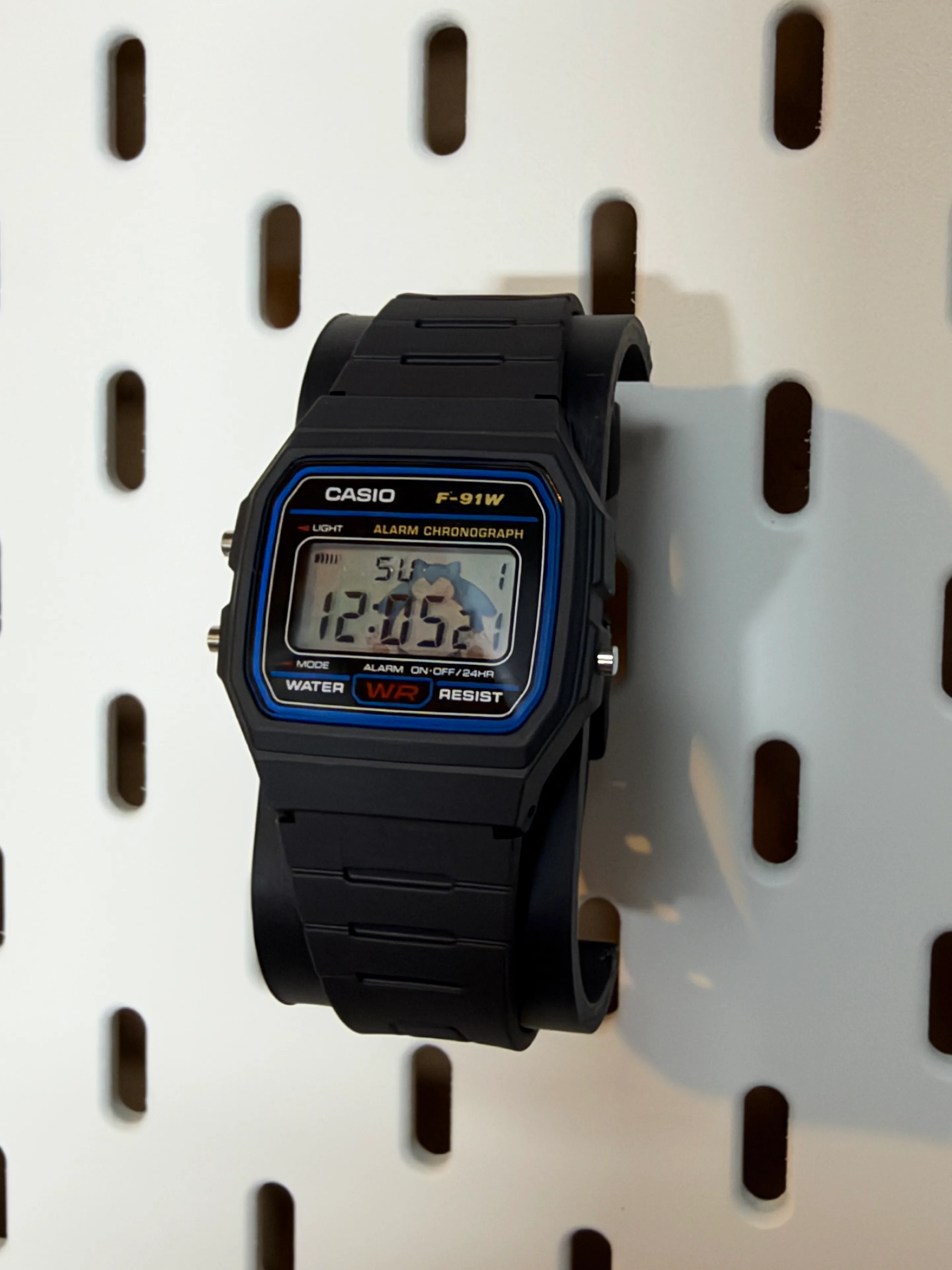 Angled view of the black Snorlax F-91W showing its original resin case and band
